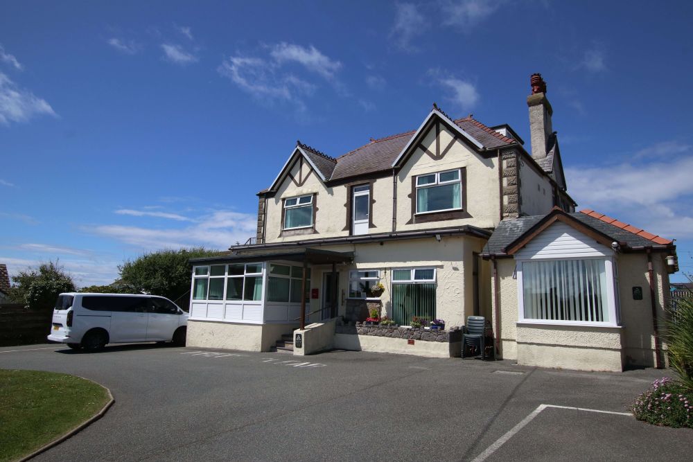 Elderly resident in a calm residential care home setting in Anglesey