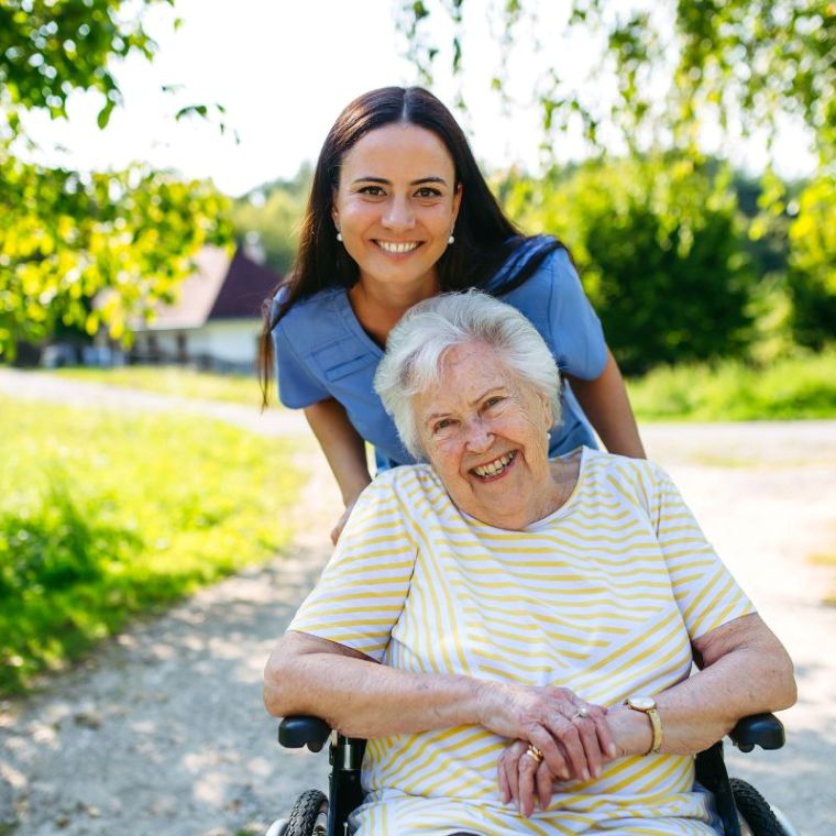 Healthcare professional speaking with an elderly resident